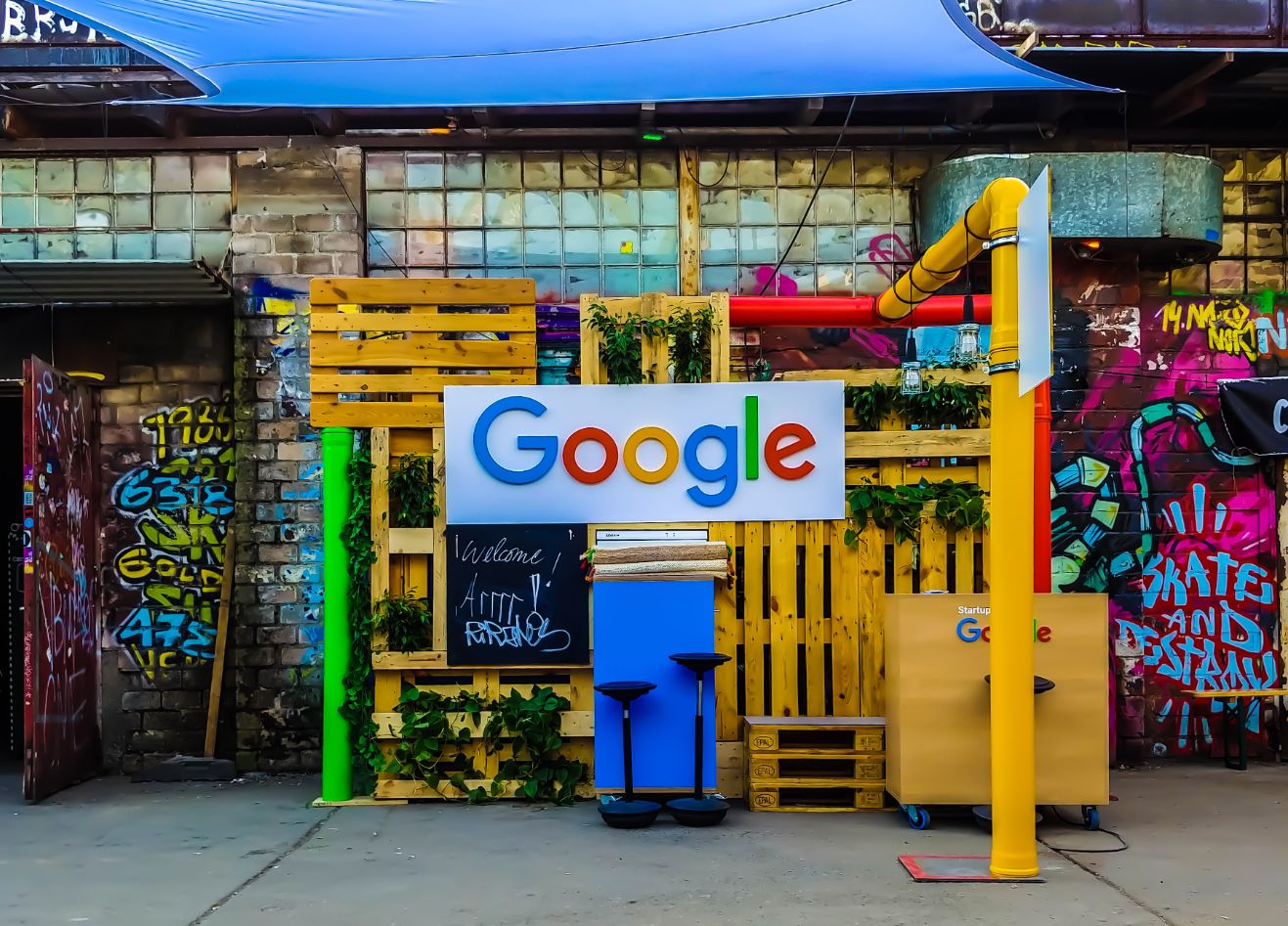 photo of google sign with graffit on building