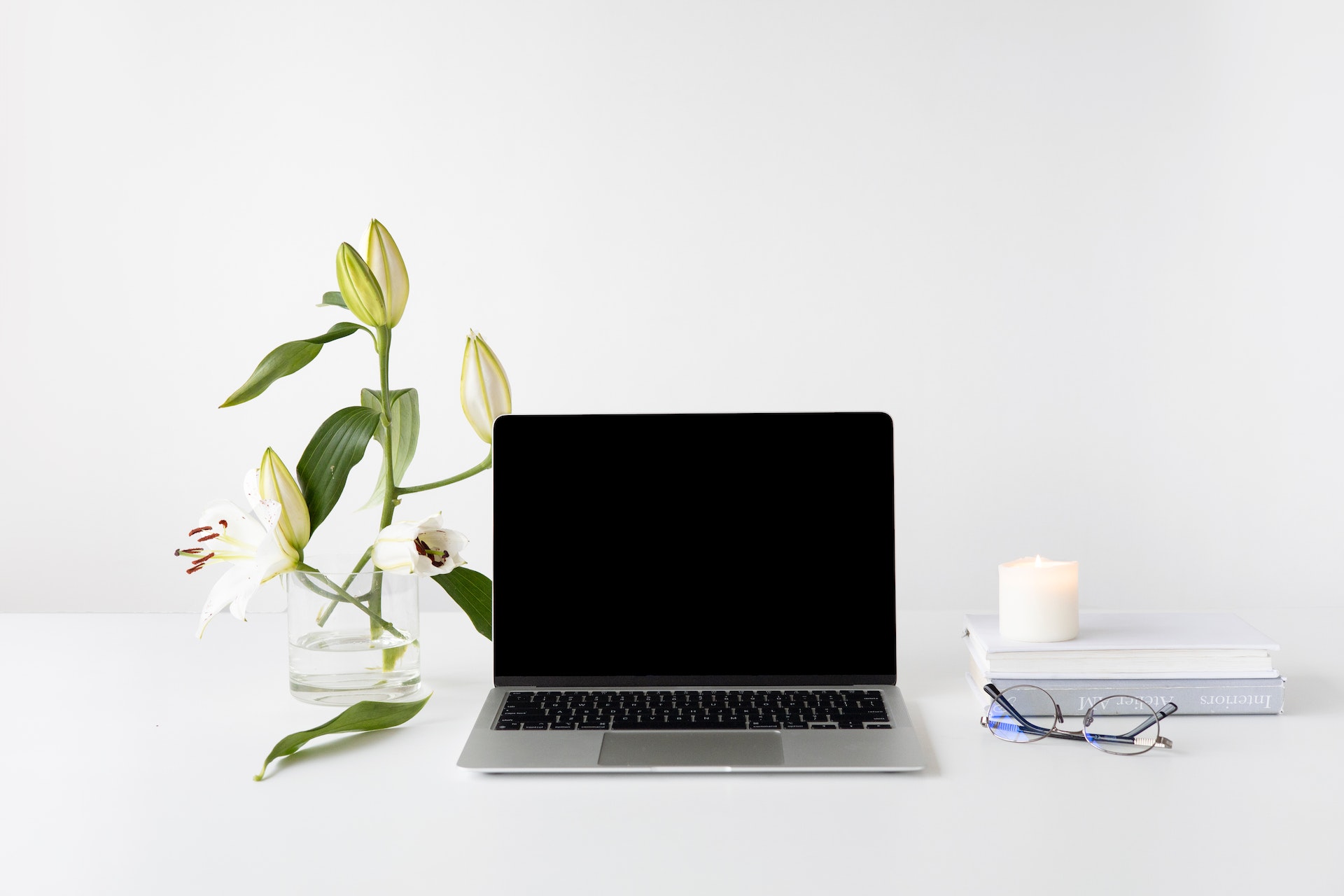 laptop on desk with flowers